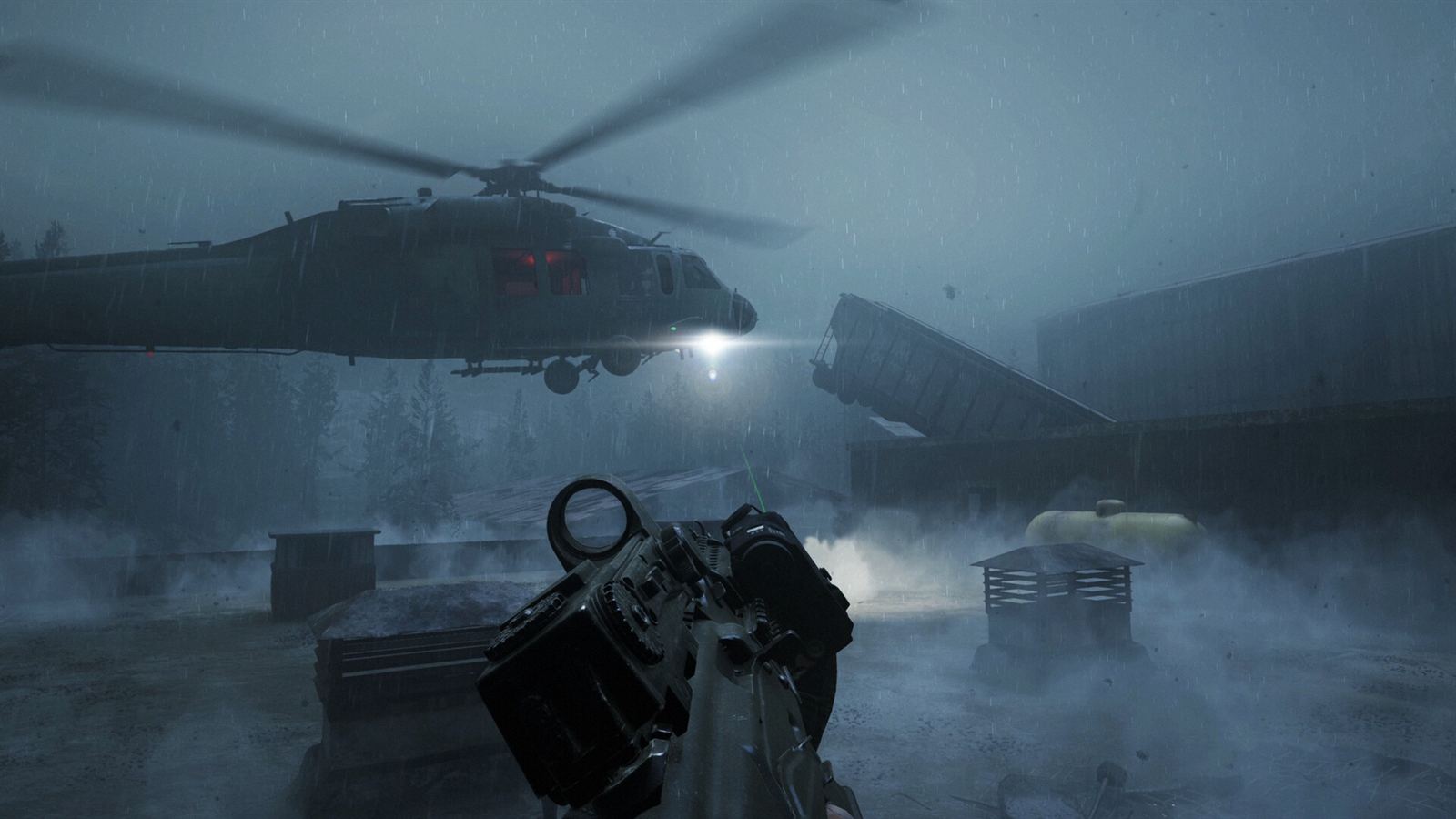 An operator raises a rifle in the fog while the extraction helicopter hovers over a flooded yard