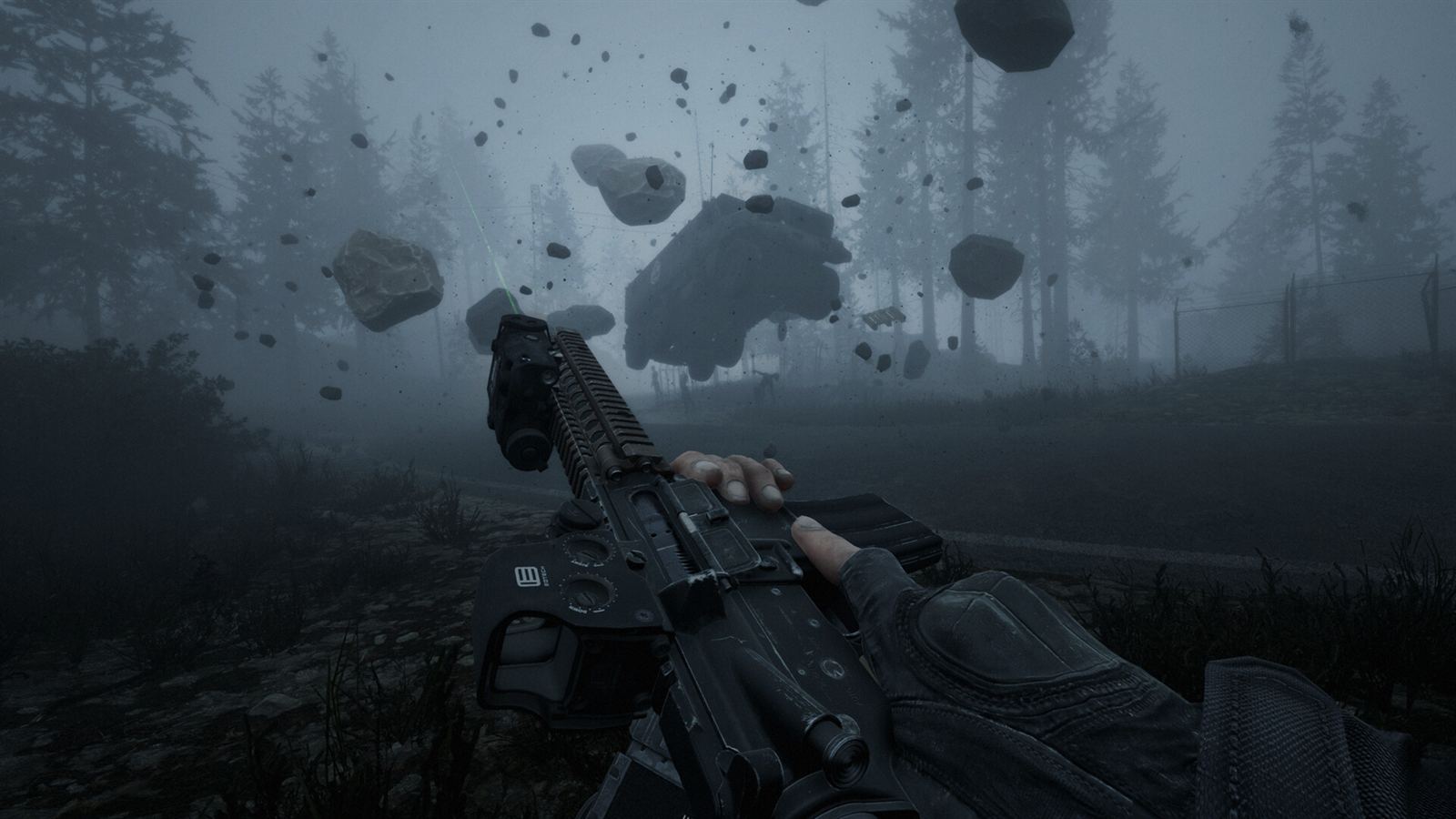 Rocks hanging motionless in the air above a fogbound forest, seen over the barrel of a rifle